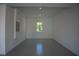 Garage with high ceilings, white walls, and epoxy flooring at 7493 Estuary Lake Loop, Kissimmee, FL 34747