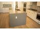 Kitchen features a large island with a modern sink and faucet at 7493 Estuary Lake Loop, Kissimmee, FL 34747
