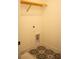 Convenient laundry room with patterned flooring and shelving at 7493 Estuary Lake Loop, Kissimmee, FL 34747