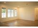 Sunlit living room featuring hardwood floors and large windows at 7493 Estuary Lake Loop, Kissimmee, FL 34747