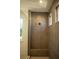 Walk-in shower with gray tile, built-in seat, and window at 7493 Estuary Lake Loop, Kissimmee, FL 34747