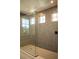 Spacious shower with gray tile and glass doors at 7493 Estuary Lake Loop, Kissimmee, FL 34747