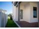 Side yard with grassy lawn and white fence at 7493 Estuary Lake Loop, Kissimmee, FL 34747