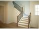 Elegant staircase featuring a mix of white and wood tones at 7493 Estuary Lake Loop, Kissimmee, FL 34747
