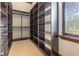 Large walk-in closet with shelving and hanging rods at 10601 Lago Bella Dr, Orlando, FL 32832