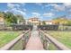 Wooden footbridge leading to a beautiful waterfront home at 10601 Lago Bella Dr, Orlando, FL 32832