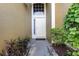 White front door with sidelights and decorative landscaping at 1314 Megan Way, Apopka, FL 32703