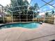 Inviting kidney-shaped pool with screened enclosure at 1314 Megan Way, Apopka, FL 32703