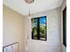 Stylish staircase with a modern light fixture and stone wall at 1970 Laurel Rd, Winter Park, FL 32789