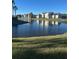 Community lake view with condo buildings reflecting in the water at 2208 Antigua Pl # 924, Kissimmee, FL 34741