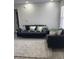 Cozy living room featuring a gray sofa and a large area rug at 2208 Antigua Pl # 924, Kissimmee, FL 34741