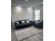 Cozy living room featuring a gray sofa and a large area rug at 2208 Antigua Pl # 924, Kissimmee, FL 34741