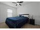 Bright bedroom with a queen bed, ceiling fan, and nightstand at 2267 Canyon Breeze Ave, Kissimmee, FL 34746