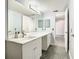 Bathroom with a white double vanity and gray tile floor at 3692 Okeechobee Cir, Casselberry, FL 32707