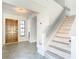 Entryway with tile floors, wooden door, and a staircase at 3692 Okeechobee Cir, Casselberry, FL 32707