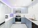 Modern kitchen featuring gray cabinets and quartz countertops at 3692 Okeechobee Cir, Casselberry, FL 32707