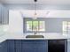 Updated kitchen with white quartz countertops and blue cabinets at 3692 Okeechobee Cir, Casselberry, FL 32707