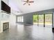 Spacious living room with fireplace, tile floors, and sliding glass doors at 3692 Okeechobee Cir, Casselberry, FL 32707