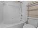 Clean bathroom with shower/tub combo and white tile at 4908 Monarch Ln, Kissimmee, FL 34746