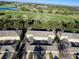 Aerial view of townhouses and a green golf course at 7128 Five Oaks Dr, Harmony, FL 34773