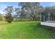 Spacious backyard with lush green grass and mature trees at 927 Pecan St, Oviedo, FL 32765