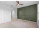 Bright bedroom with wood ceiling fan, green accent wall, and carpet flooring at 927 Pecan St, Oviedo, FL 32765