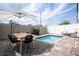 Private backyard with a plunge pool and dining area at 212 Villa Domani Cir, Davenport, FL 33896