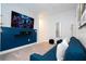 Game room with a large TV, blue sofa, and accent pillows at 212 Villa Domani Cir, Davenport, FL 33896