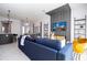 Open concept living area with a blue sofa and dining table at 212 Villa Domani Cir, Davenport, FL 33896
