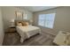 Second bedroom with a queen bed and geometric carpet at 2774 Bright Bird Ln, Winter Park, FL 32792