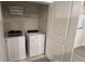 Convenient laundry room with washer, dryer, and shelving at 2774 Bright Bird Ln, Winter Park, FL 32792