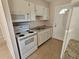 Kitchen with white cabinets, appliances, and granite countertop at 5831 W Amelia St, Orlando, FL 32835