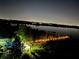Night view of lakefront walkway and pool area at 6336 Buford St # 705, Orlando, FL 32835