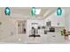 Modern kitchen with white cabinets, quartz countertops and teal lighting at 6336 Buford St # 705, Orlando, FL 32835