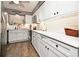 Modern kitchen with white cabinets, quartz countertops, and stainless steel appliances at 730 E Michigan St # 139, Orlando, FL 32806