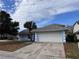 Cute light blue house with a white garage door and palm tree at 762 Rosalie Way, Winter Springs, FL 32708