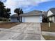Light blue house with a white garage door and driveway at 762 Rosalie Way, Winter Springs, FL 32708
