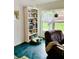 Cozy living room featuring a bookcase and leather chair at 762 Rosalie Way, Winter Springs, FL 32708
