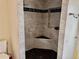 Modern shower with gray tile and a built-in seat at 762 Rosalie Way, Winter Springs, FL 32708