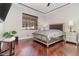 Bright bedroom with hardwood floors, a large bed and a ceiling fan at 9168 Lake Avon Dr, Orlando, FL 32829
