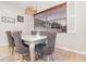 Bright dining room features a silver table, gray chairs, and large window with blinds at 9168 Lake Avon Dr, Orlando, FL 32829
