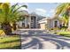 Two-story house with gray exterior, paver driveway, and palm trees at 9168 Lake Avon Dr, Orlando, FL 32829