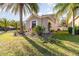 Side view of a two-story house with gray exterior, landscaping, and palm trees at 9168 Lake Avon Dr, Orlando, FL 32829