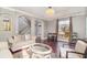 Spacious living room with hardwood floors, large windows, and comfortable seating at 9168 Lake Avon Dr, Orlando, FL 32829