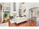 Two-story living room with hardwood floors, fireplace, and built-in shelving at 9168 Lake Avon Dr, Orlando, FL 32829