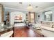 Elegant living room boasts hardwood floors, a white brick fireplace, and ample natural light at 9168 Lake Avon Dr, Orlando, FL 32829