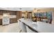 Kitchen with breakfast bar, wood cabinets, and white appliances at 9830 Jackson Rd, Leesburg, FL 34788