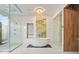 Spa-like Primary bathroom with freestanding tub, large shower, and modern chandelier at 10230 Park Ridge Gotha Rd, Windermere, FL 34786