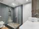 Contemporary bathroom with glass shower and pebble flooring at 10230 Park Ridge Gotha Rd, Windermere, FL 34786