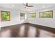 Spacious bedroom with hardwood floors and multiple windows at 10230 Park Ridge Gotha Rd, Windermere, FL 34786